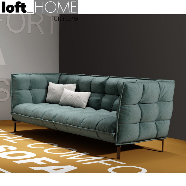 Modern fabric 3 seater sofa husk in still life.