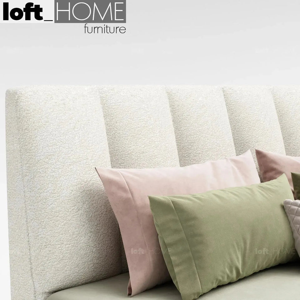 Cream sheepskin fabric bed cory in panoramic view.