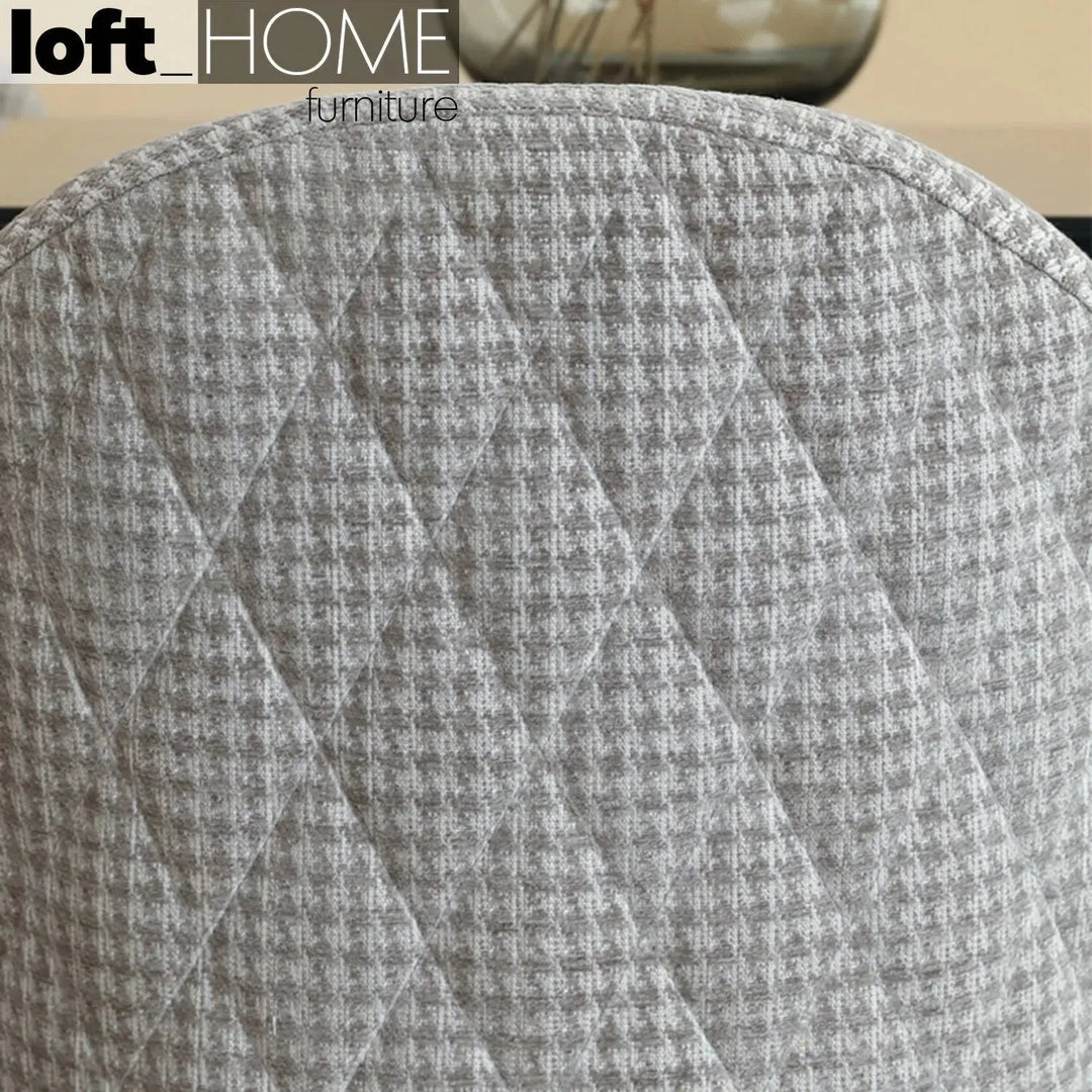 Modern fabric dining chair houndstooth in close up details.