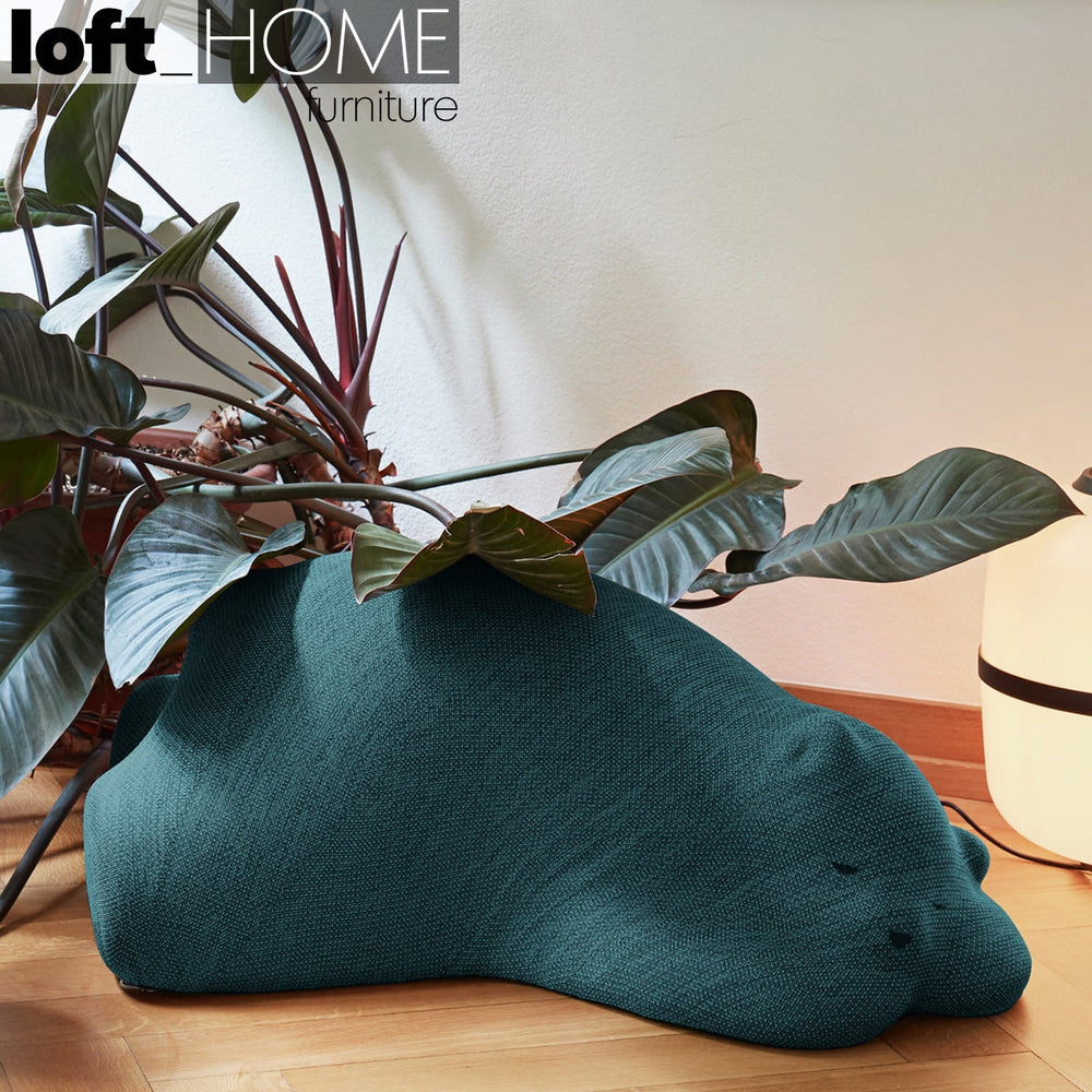 Modern knit fabric ottoman resting bear primary product view.