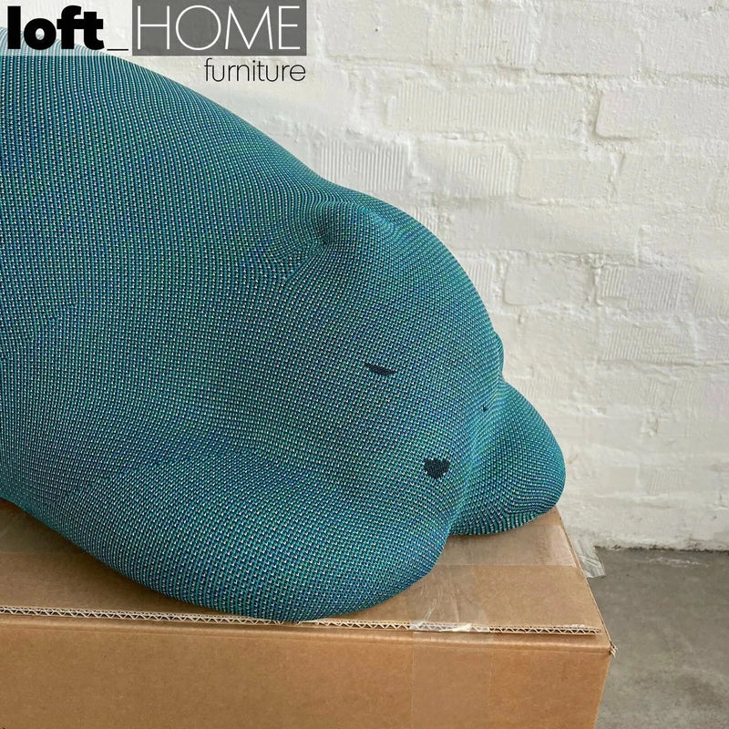 Bauhaus knit fabric ottoman resting bear in still life.