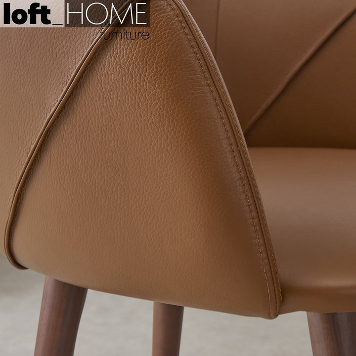Modern leather armrest dining chair lule arm with context.