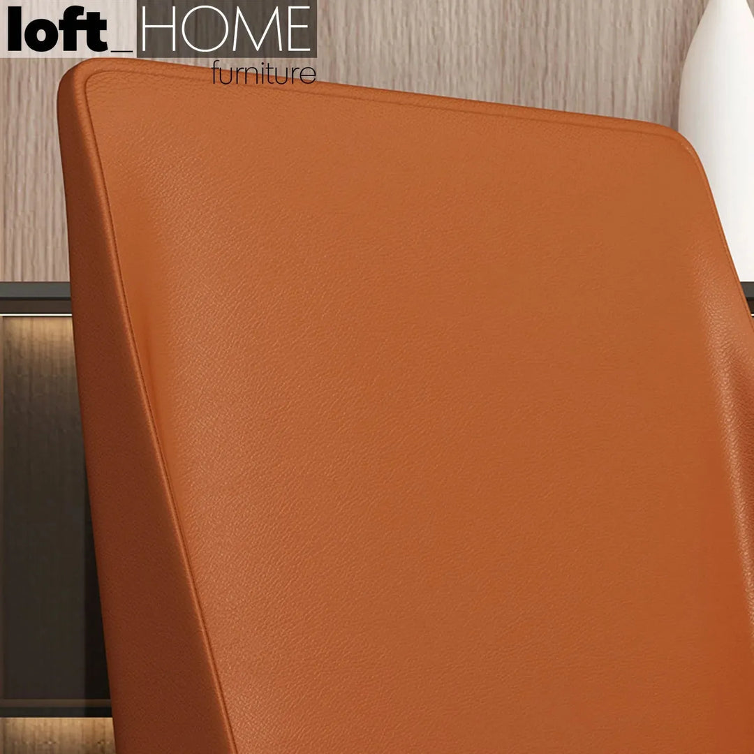 Modern pu leather dining chair orange in close up details.