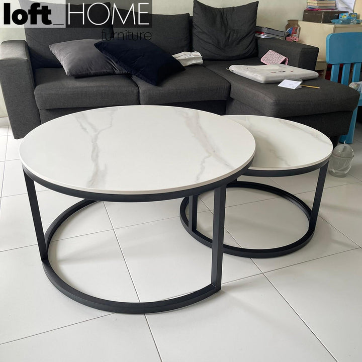 Modern sintered stone coffee table black with context.