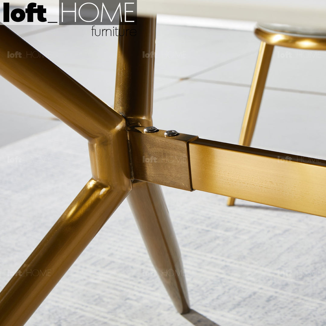 Modern sintered stone dining table spider gold with context.