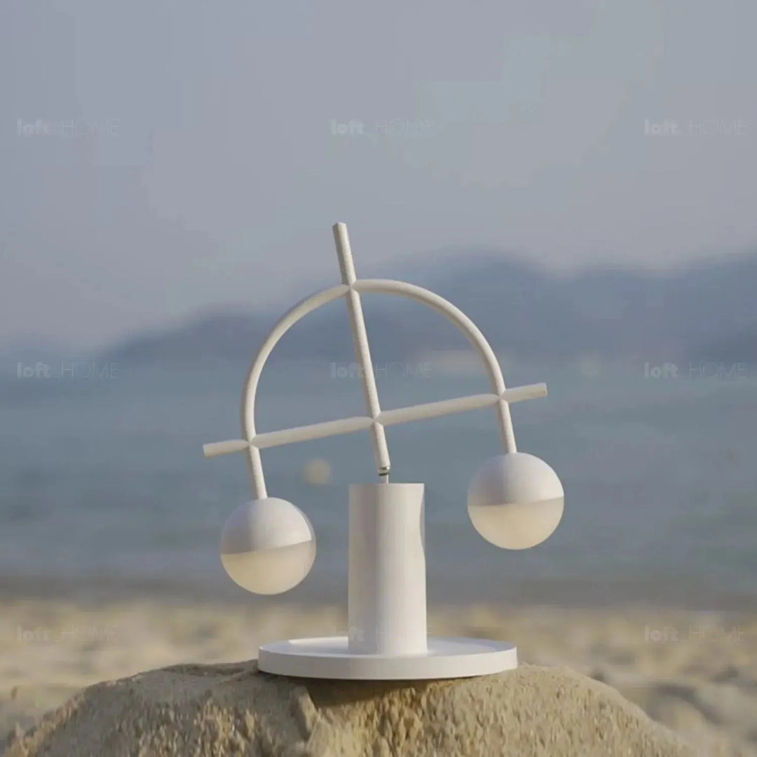 Contemporary steel charging table lamp balance in still life.