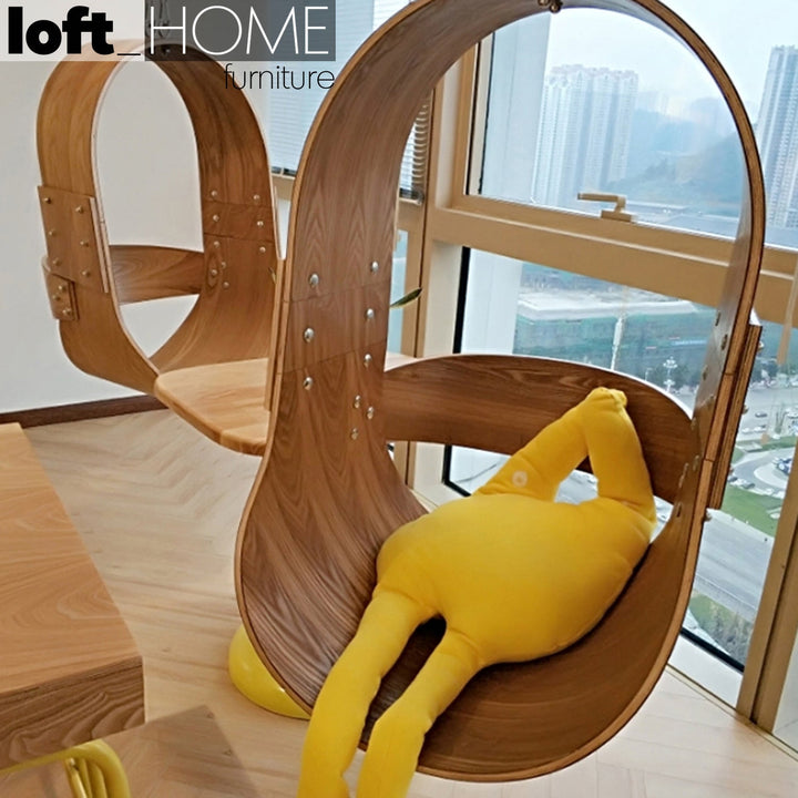 Modern wood hanging chair 1 seater sofa plywood in panoramic view.