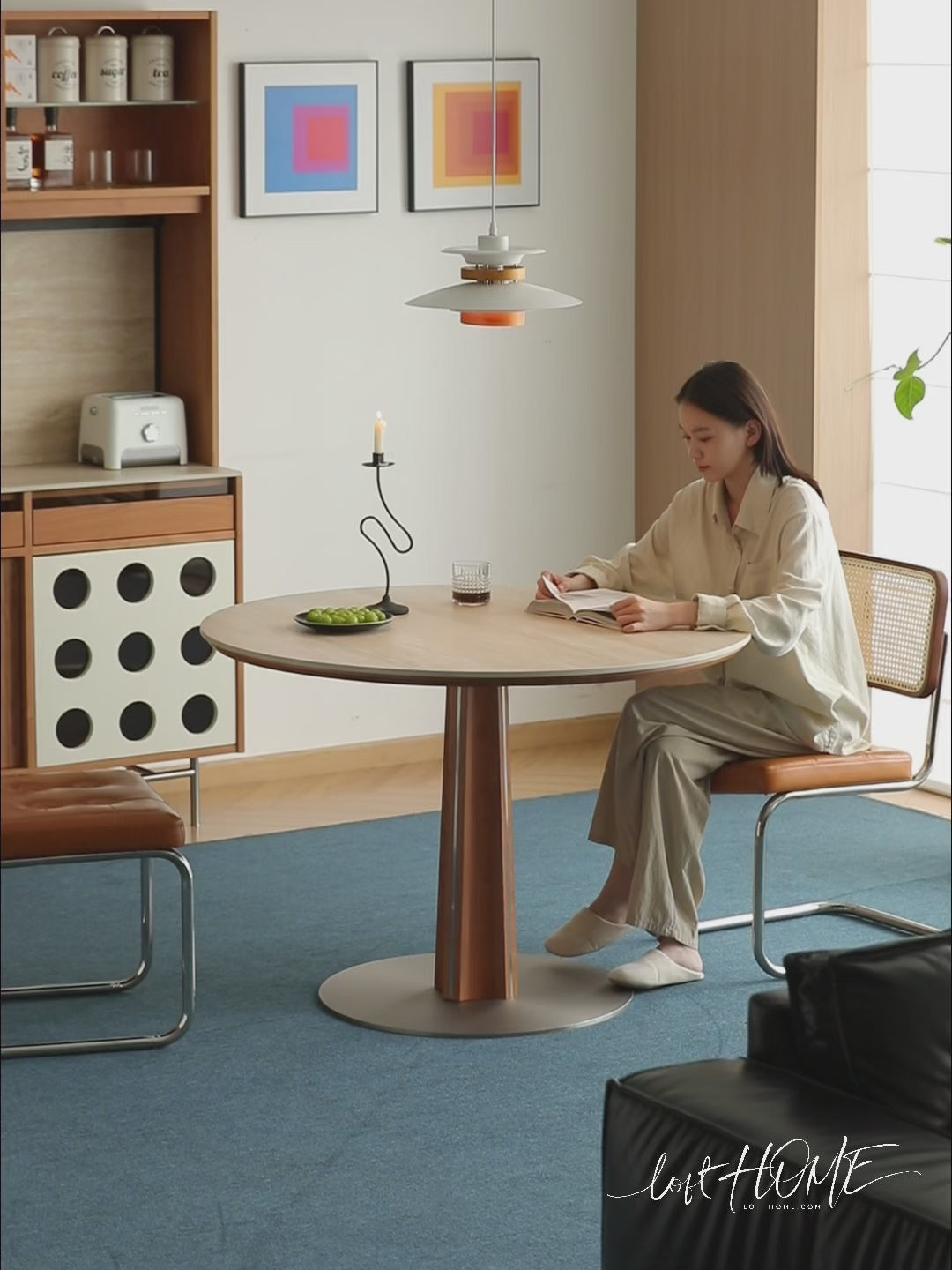 Bauhaus cherry wood sintered stone round dining table pinecone in still life.