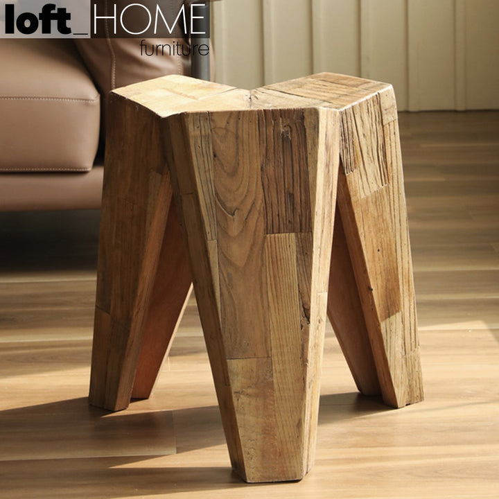 Rustic elm wood stool tripod in close up details.
