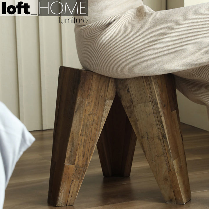 Rustic elm wood stool tripod in details.
