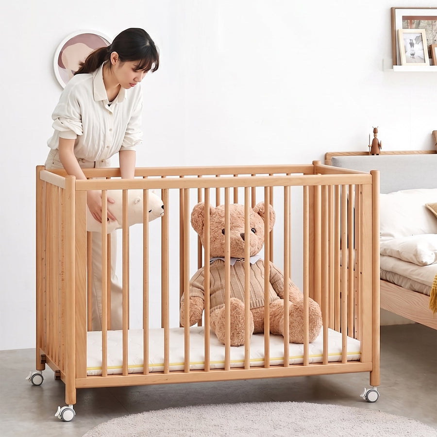Scandinavian beech wood bed side baby crib with wheels ember primary product view.