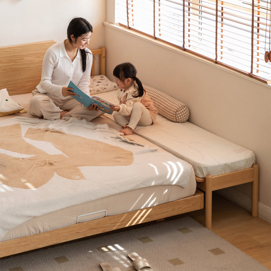 Scandinavian beech wood height adjustable kids sidecar bed with mattress anchor primary product view.