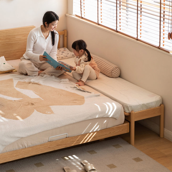 Scandinavian beech wood height adjustable kids sidecar bed with mattress anchor primary product view.