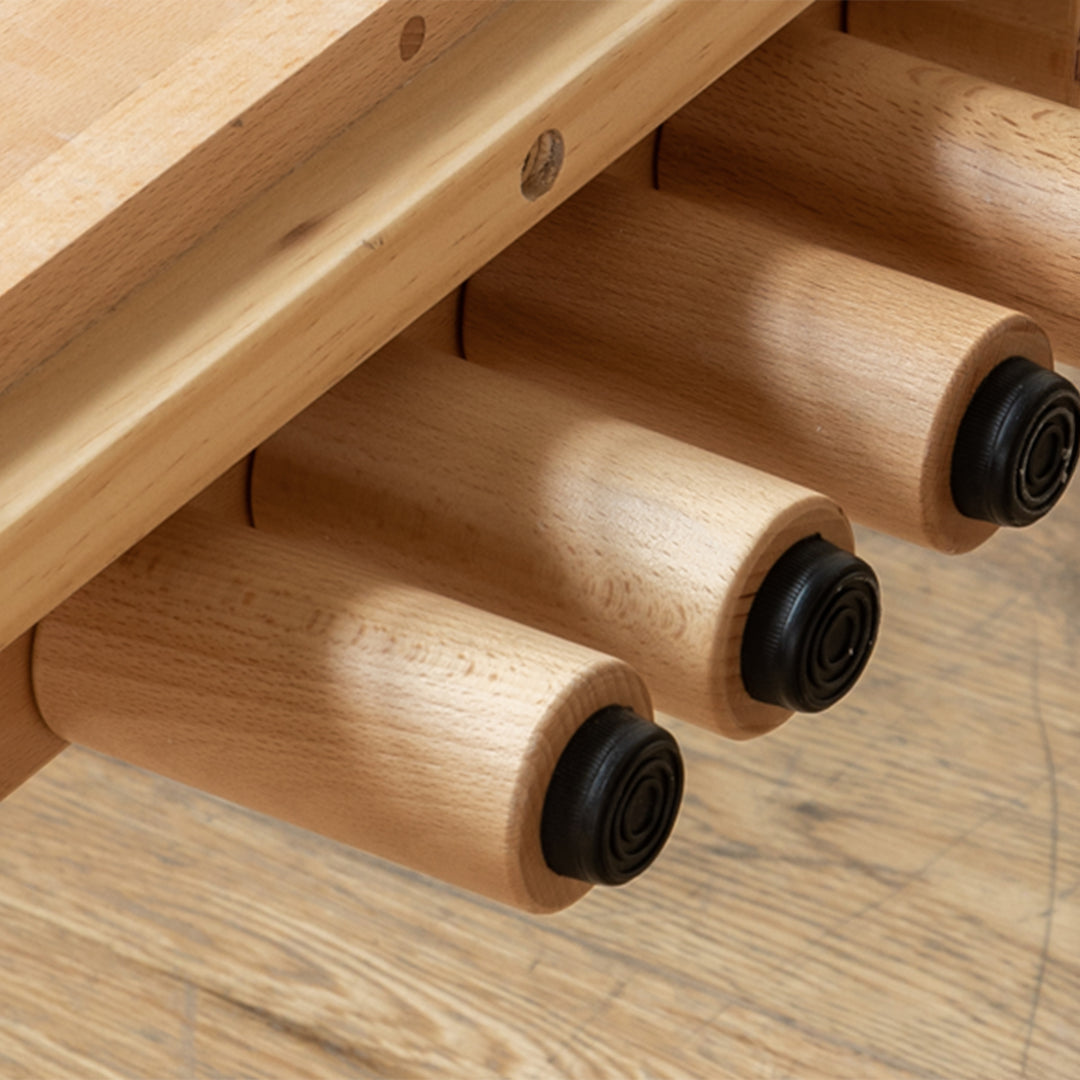 Scandinavian beech wood height adjustable kids sidecar bed with mattress anchor in still life.