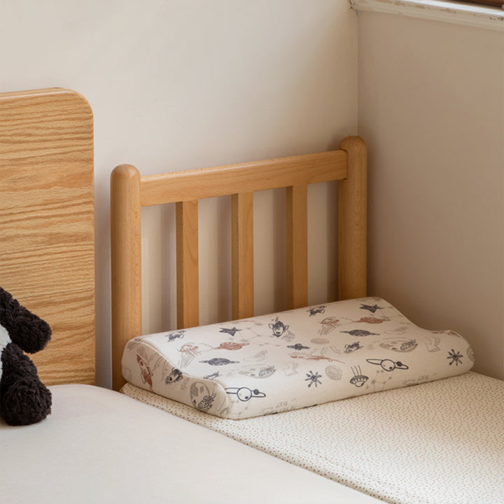 Scandinavian beech wood height adjustable kids sidecar bed with mattress anchor in panoramic view.