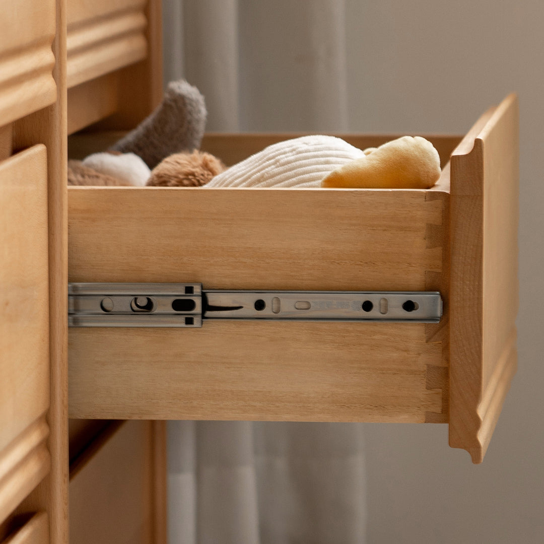 Scandinavian beech wood kids chest of drawers creamy in panoramic view.