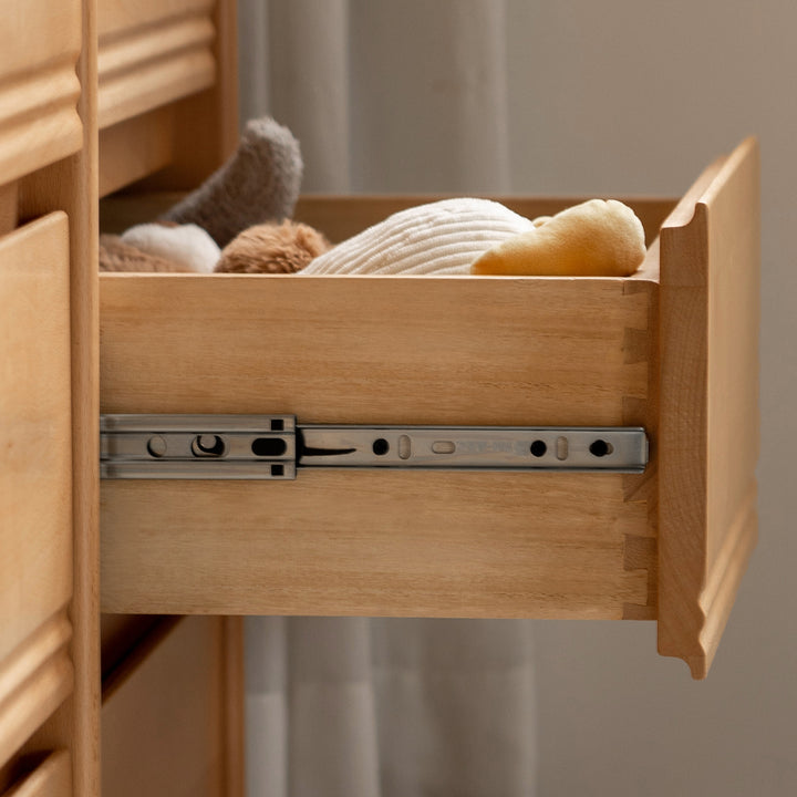 Scandinavian beech wood kids chest of drawers creamy in panoramic view.