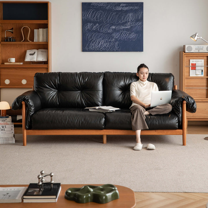 Scandinavian chenille velvet fabric cherry wood 3 seater sofa open backed in close up details.