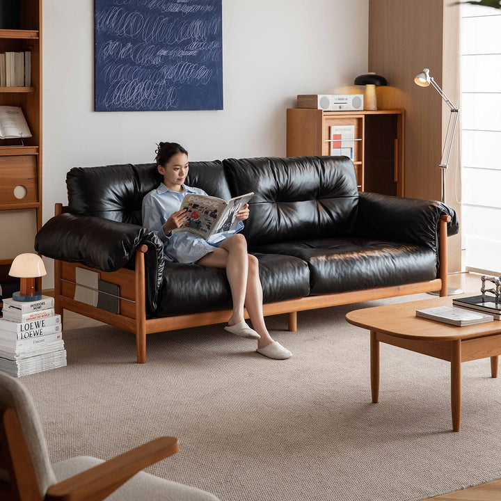 Scandinavian chenille velvet fabric cherry wood 3 seater sofa open backed in panoramic view.