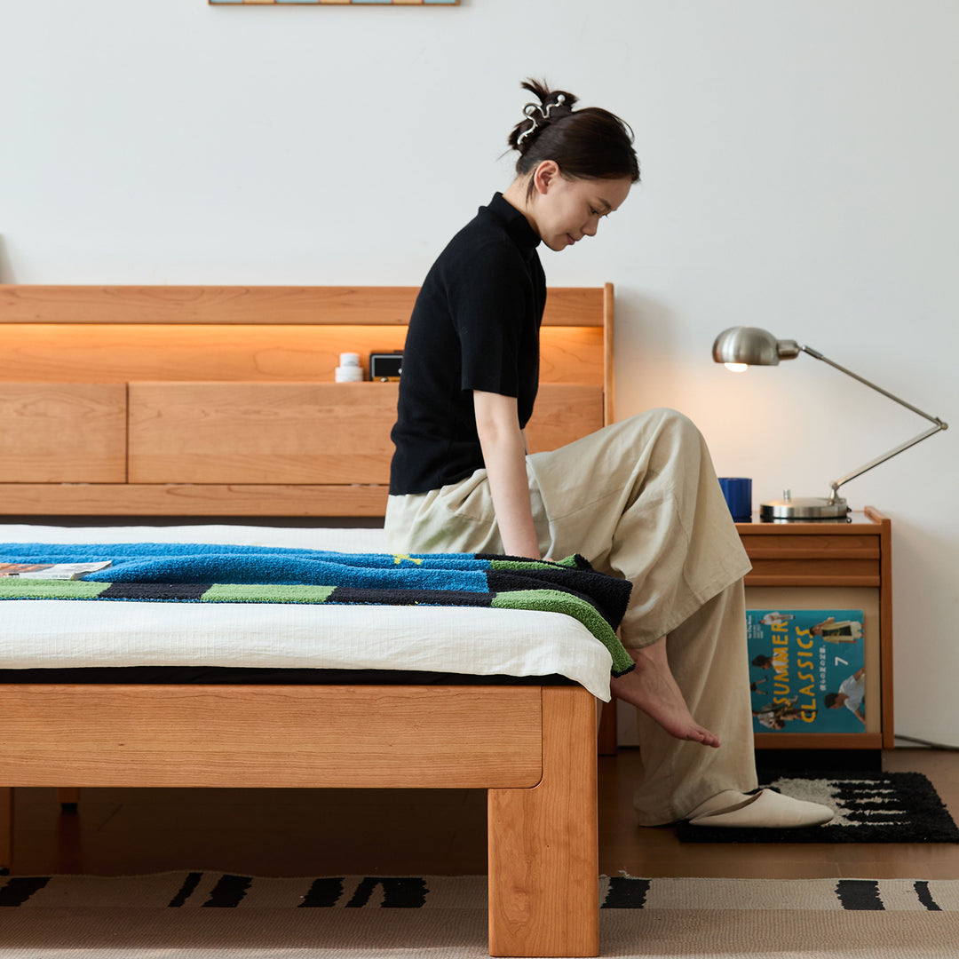 Scandinavian cherry wood bed accompany light in close up details.