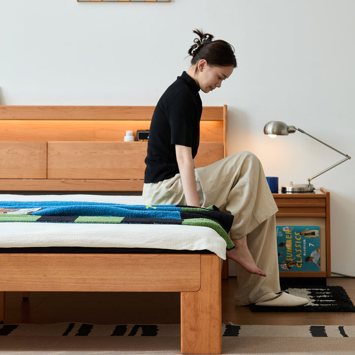 Scandinavian cherry wood bed accompany light in close up details.