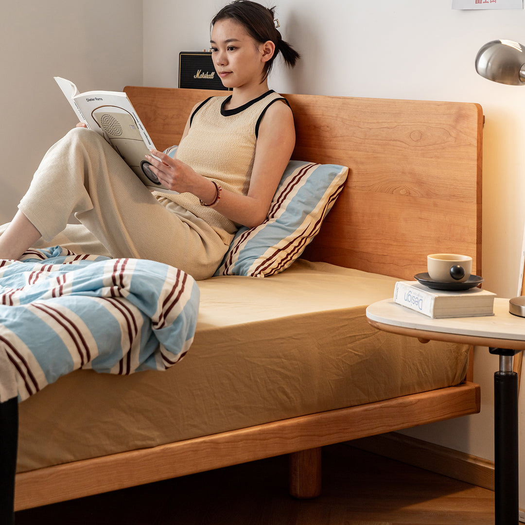 Scandinavian cherry wood bed small in real life style.