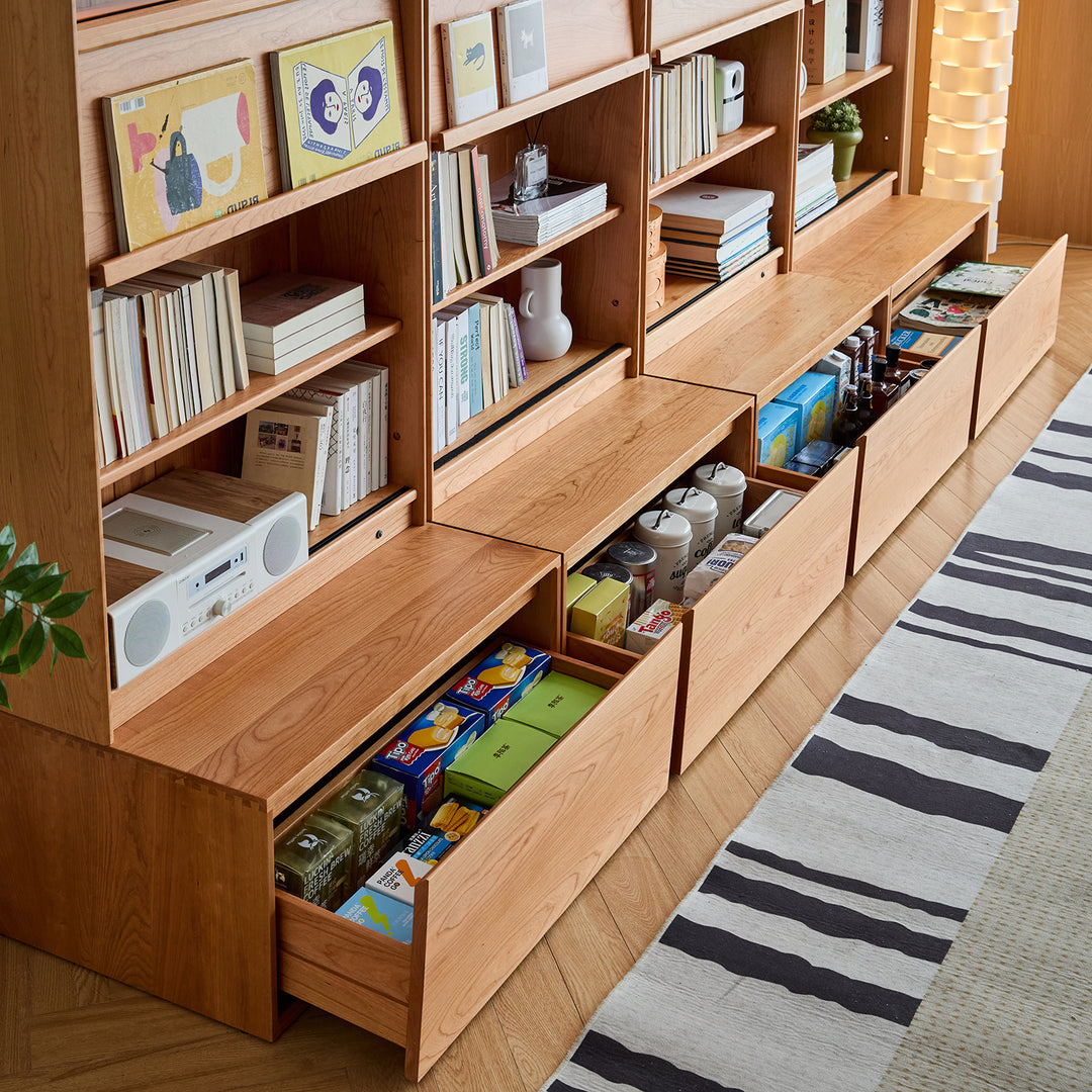 Scandinavian cherry wood bookshelf vista with context.