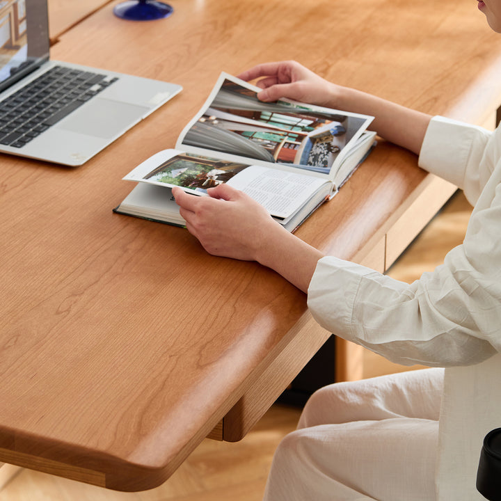 Scandinavian cherry wood electric height adjustable study table cloud lifting in close up details.