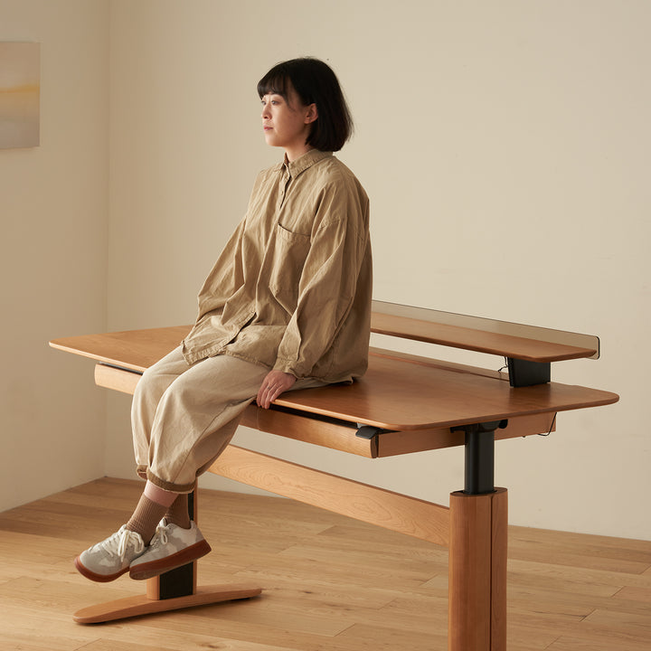 Scandinavian cherry wood electric height adjustable study table up in real life style.