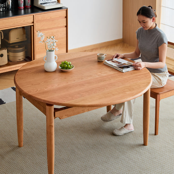 Scandinavian cherry wood extendable dining table minima in close up details.