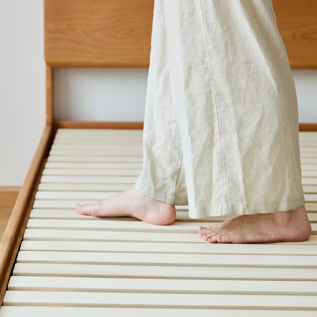 Scandinavian cherry wood lift-up storage bed square box in still life.