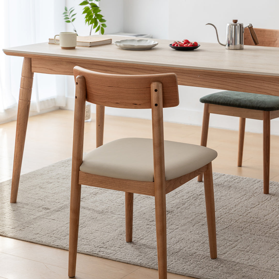 Scandinavian cherry wood mixed weave fabric dining chair green in close up details.
