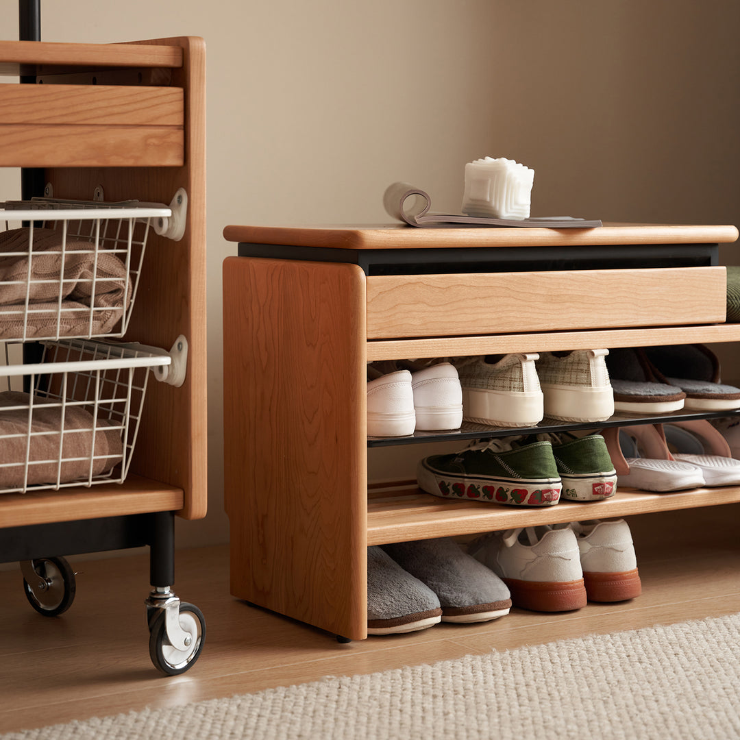 Scandinavian cherry wood shoe changing bench mori with context.