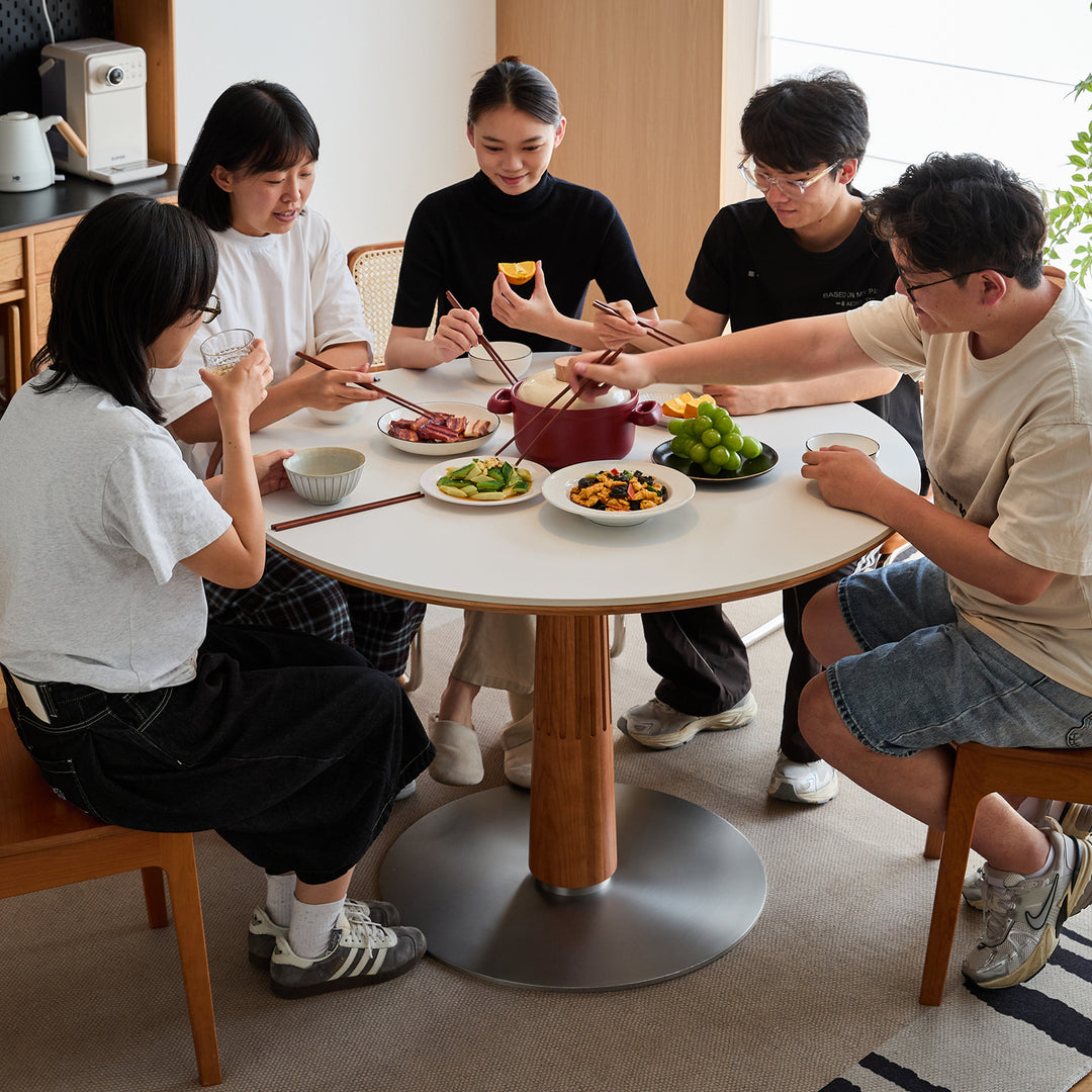 Scandinavian cherry wood sintered stone round dining table grey in still life.