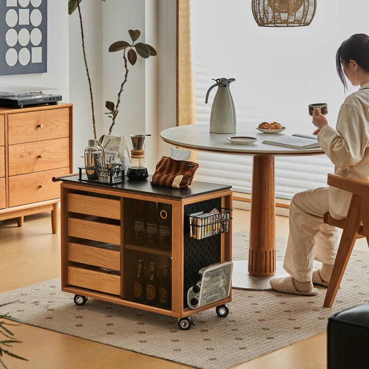 Scandinavian cherry wood wheeled trolley side table bus in close up details.