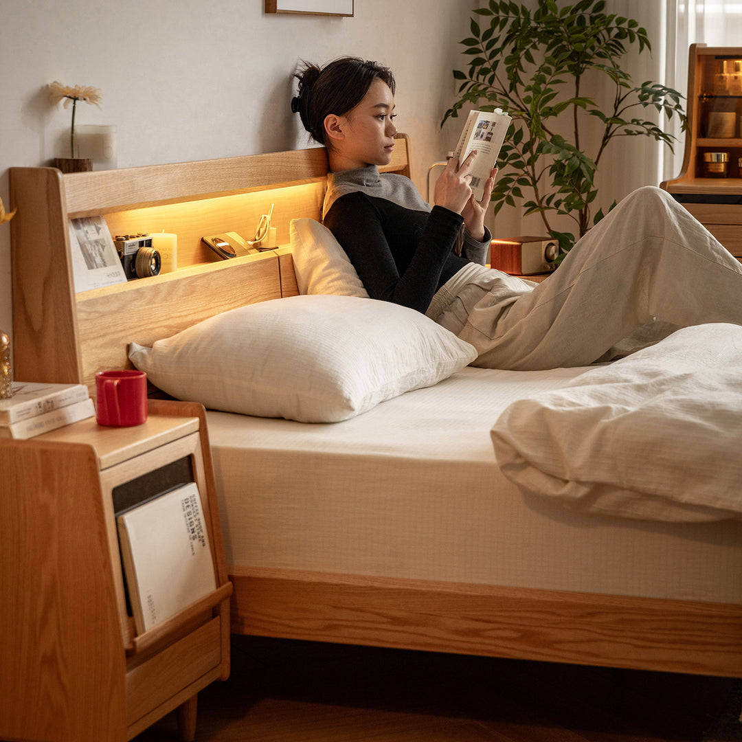 Scandinavian oak wood bed accompany light with context.