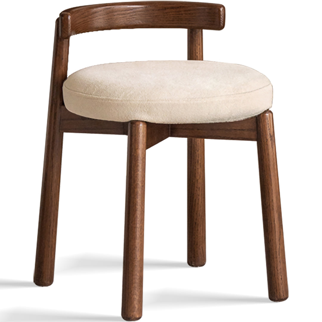 Scandinavian oak wood boucle fabric dressing chair turni in still life.
