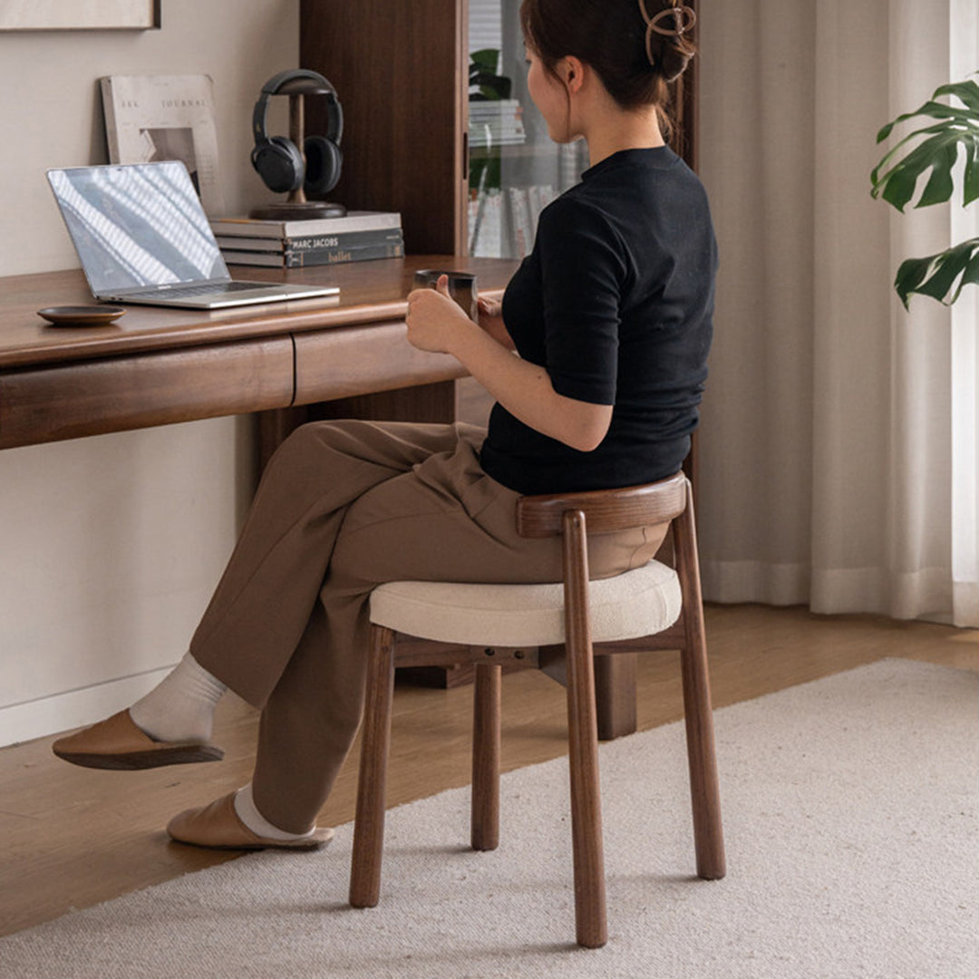 Scandinavian oak wood boucle fabric dressing chair turni in real life style.