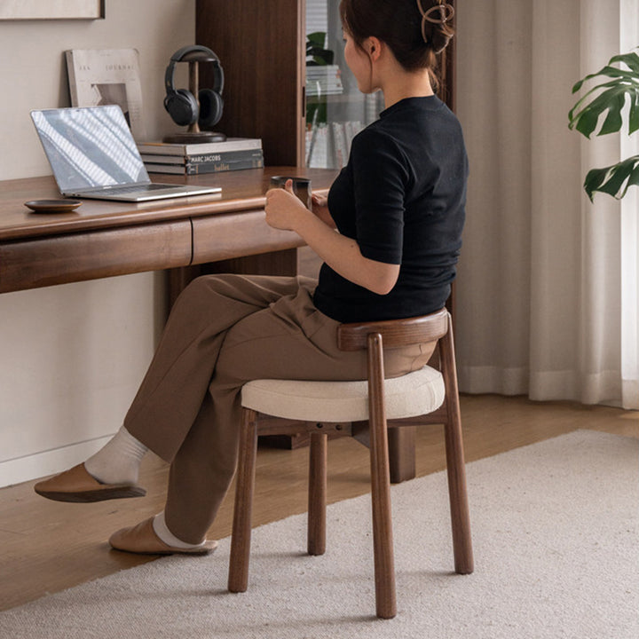 Scandinavian oak wood boucle fabric dressing chair turni in real life style.