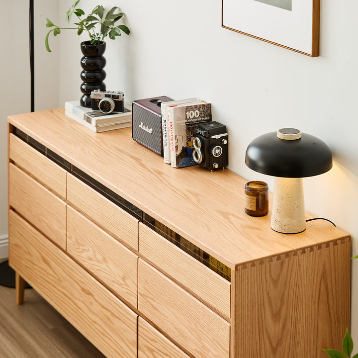 Scandinavian oak wood chest of 8 drawers floating light in real life style.