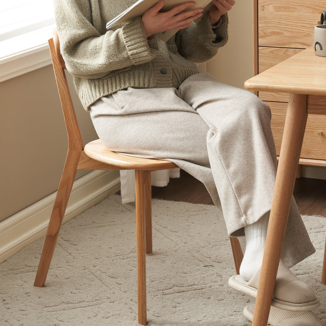 Scandinavian oak wood dining chairs elm in close up details.