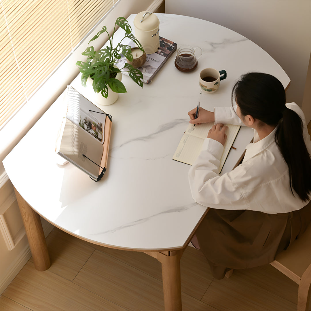 Scandinavian oak wood sintered stone extendable round dining table orbit in close up details.