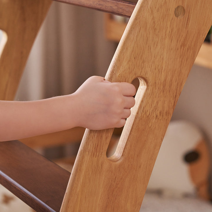 Scandinavian rubber wood kids bunk bed with bottom drawers and wall shelf little bear in close up details.