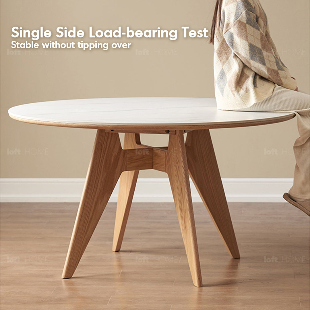 Scandinavian sintered stone round dining table belly layered structure.