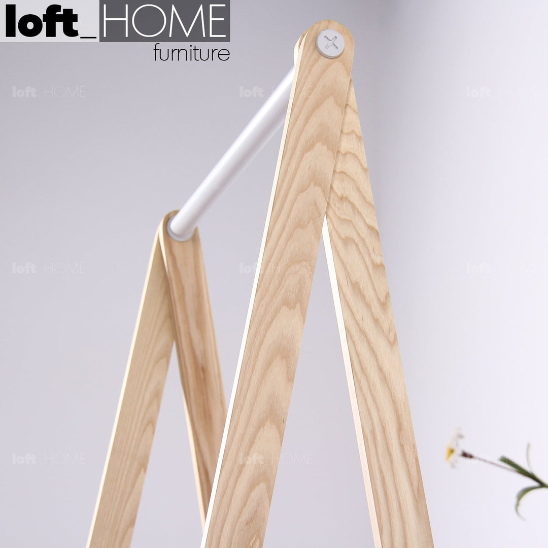 Scandinavian wood cloth hanger shelf toj in close up details.