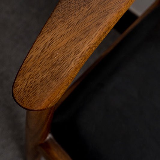 Scandinavian wood dining chair walnut president in close up details.