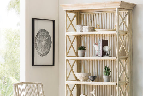 Light and airy room featuring a tall wooden shelving unit with decorative items, a matching wooden chair, and botanical decor, linking to Loft Home's shelves collection.