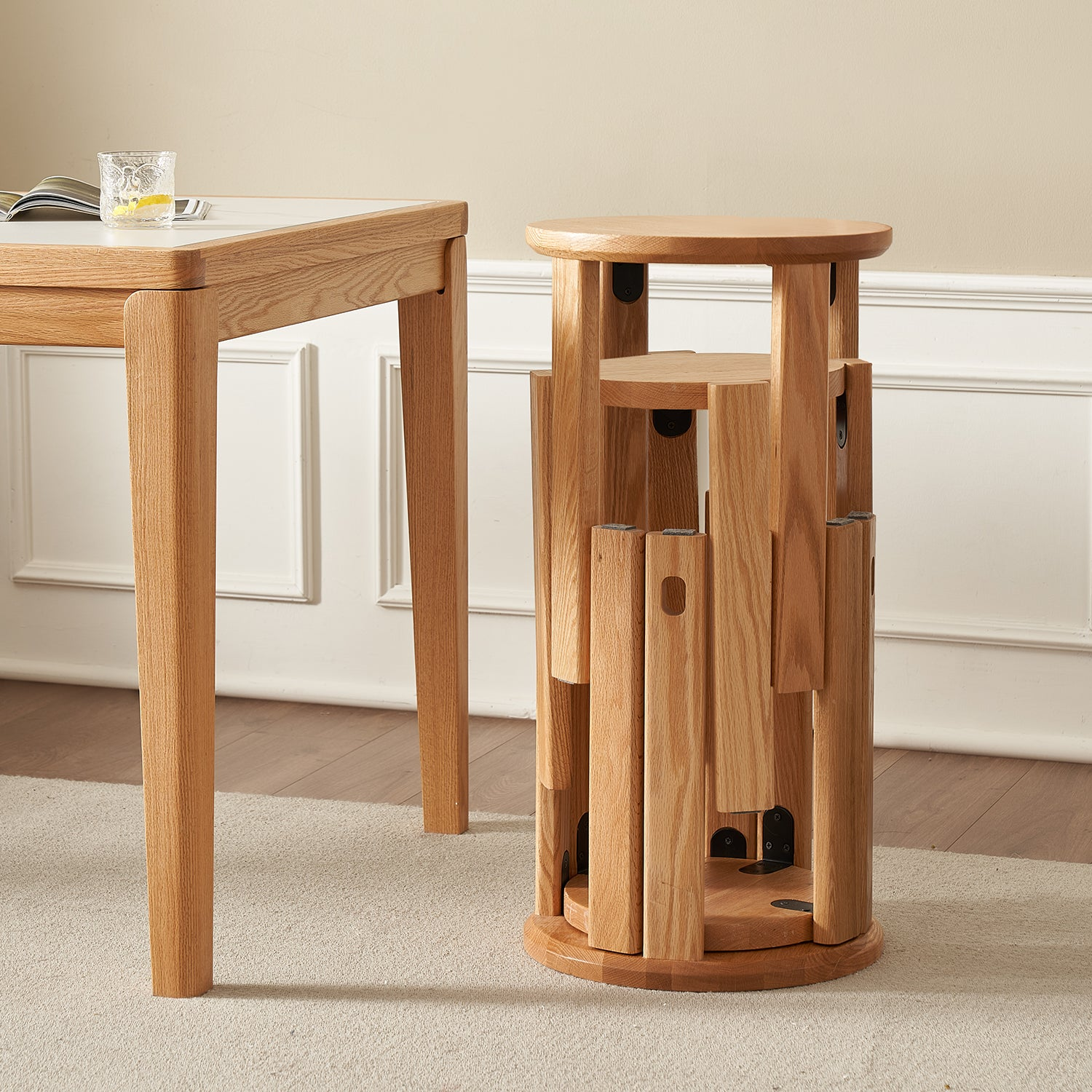 Scandinavian-inspired room with a wooden table and unique wooden stool, creating a minimalist and natural aesthetic.