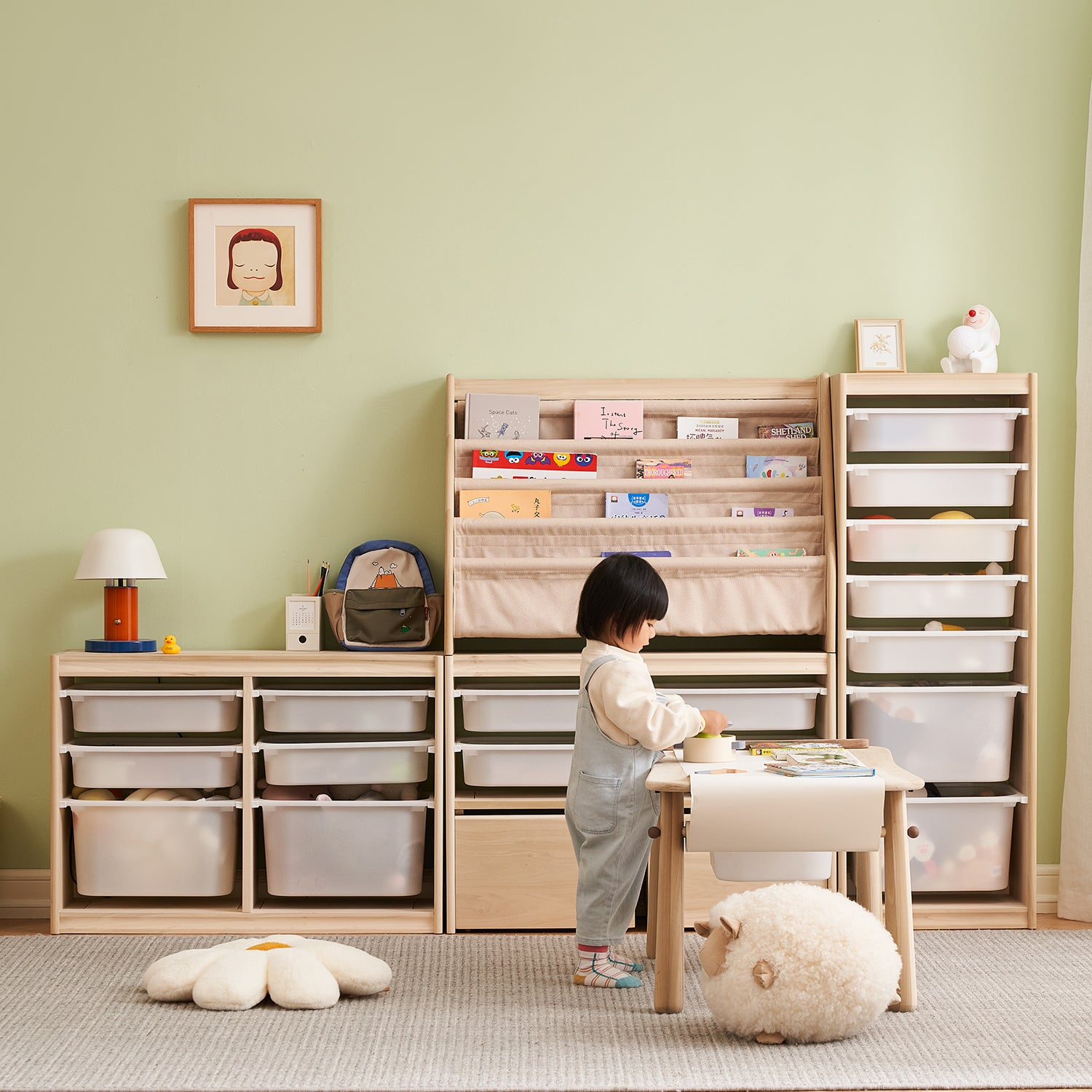 Child's playroom with wooden storage units, books, toys, a table, and a toddler playing, creating an organized and cheerful environment.