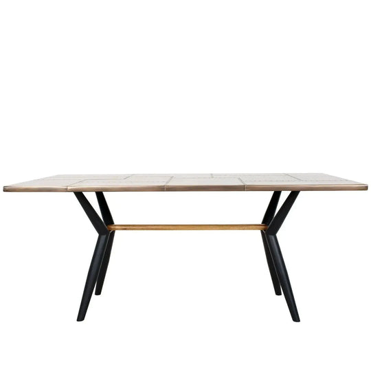Industrial brass dining table lucien brass in white background.